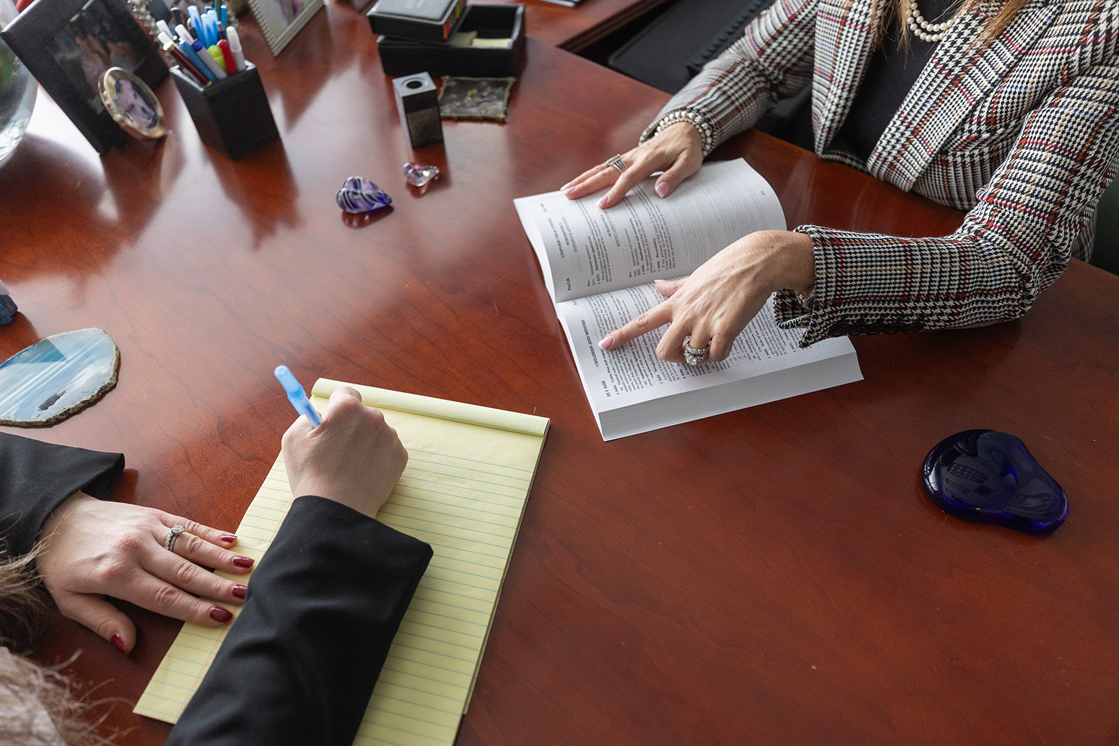 attorneys at desk with book and legal pad - divorce arbitration lawyers - Feinman & Childs Family Law