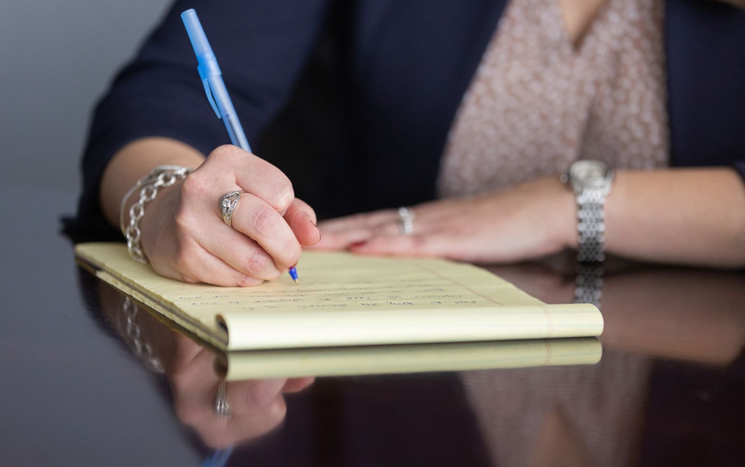 person writing notes on a legal pad | parenting coordination | Feinman & Childs Family Law